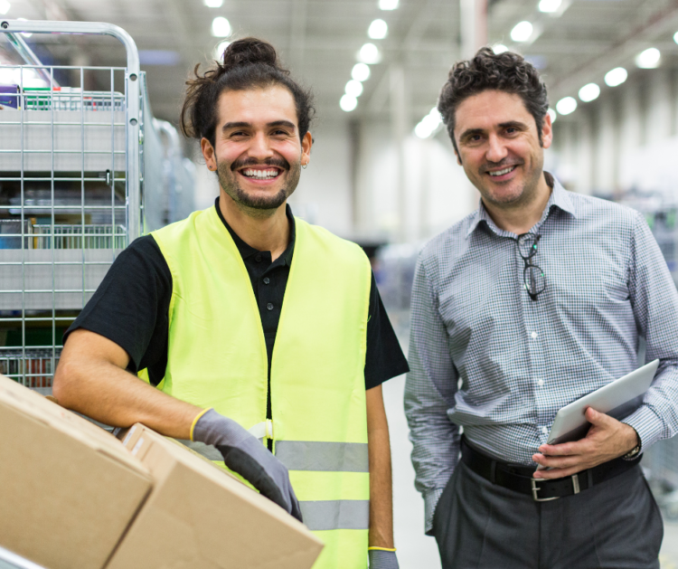 Younger and Older Warehouse Employees Smiling